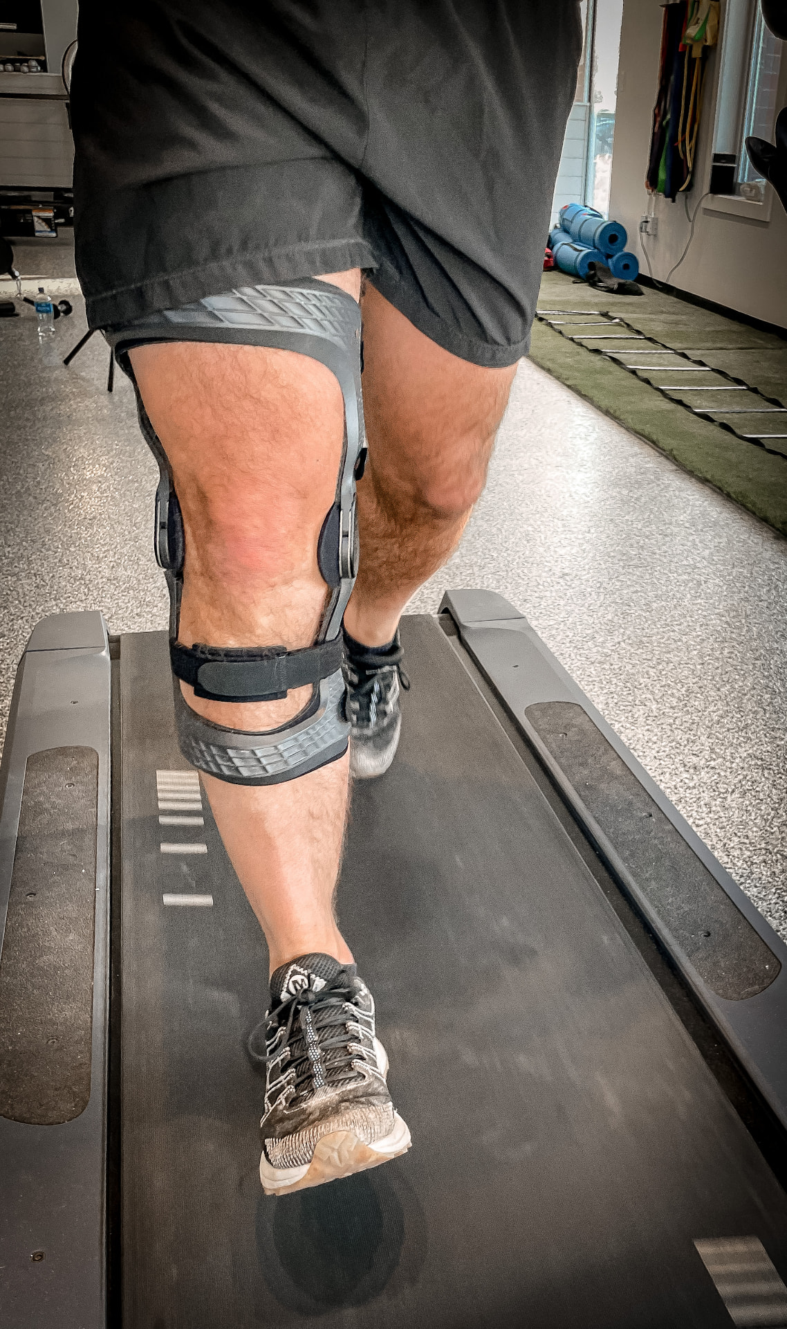 Athlete running on a treadmill in a custom-built knee brace