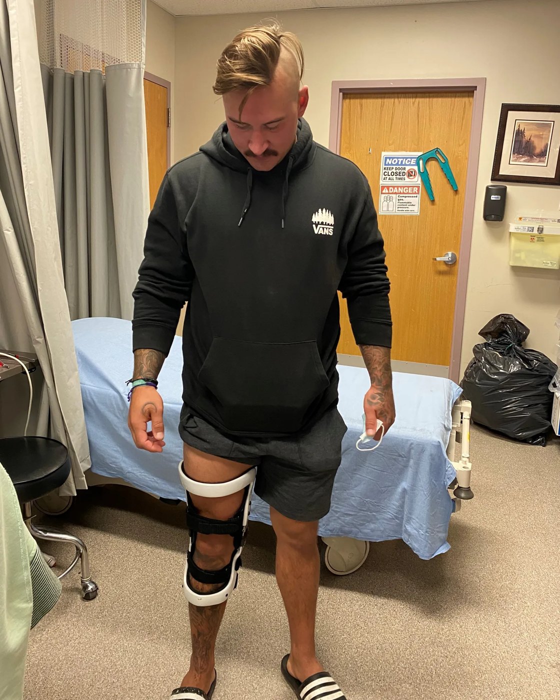 Patient wearing a fitted custom knee brace in the clinic
